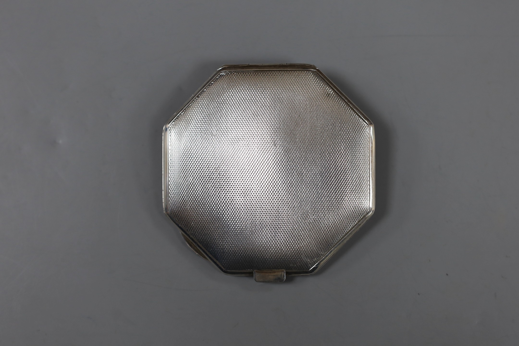 A George VI octagonal silver and blue enamel compact, with regimental appliqué, Birmingham, 1937, 80mm.